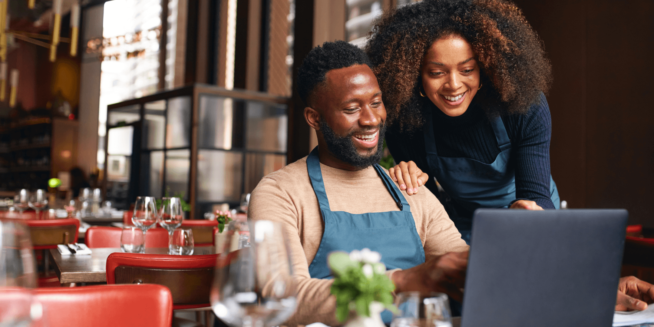 Restaurant owners reviewing their laptop